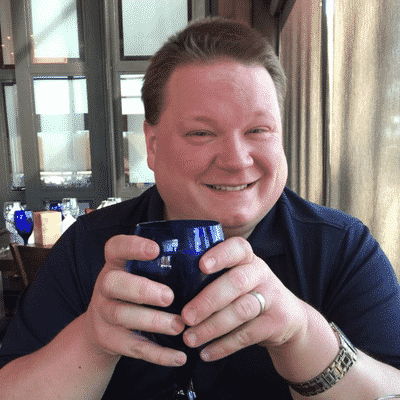 The direct response copywriter, Robert Sean Pascoe, can again be seen holding a coffee mug while smiling in a different picture.