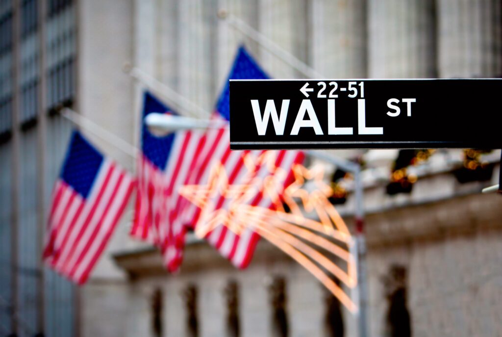 Wall street sign in New York with New York Stock Exchange background